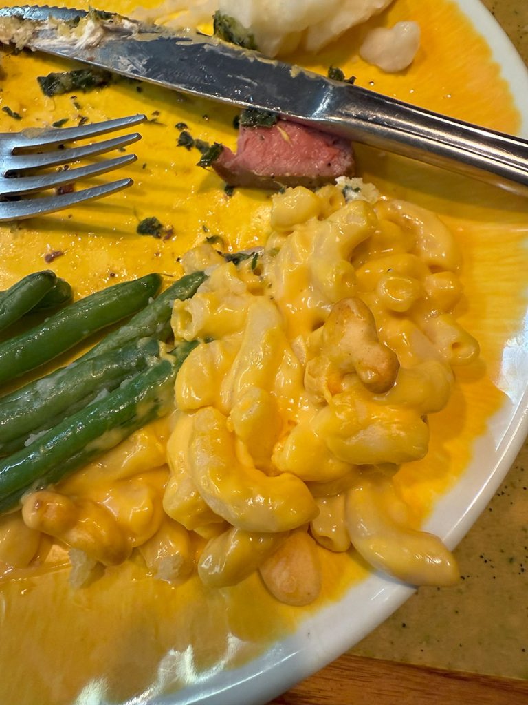 Macaroni with goldfish on a yellow plate at Garden Grill Epcot